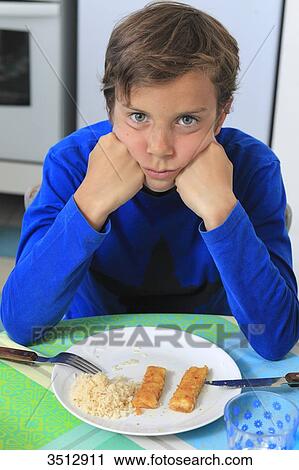 France, child eating breaded fish View Large Photo Image Stock Image - France, child eating breaded fish. Fotosearch