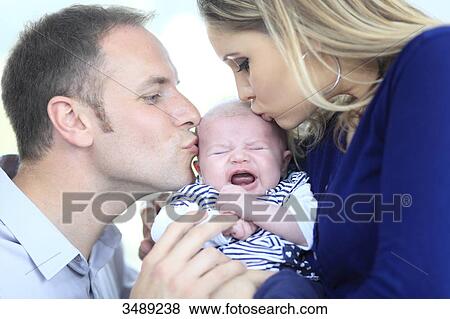 France, couple kissing his baby View Large Photo Image Stock Photo - France, couple kissing his baby. Fotosearch