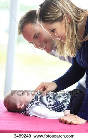 France, couple looking at baby View Large Photo Image Stock Photo - France, couple looking at baby. Fotosearch