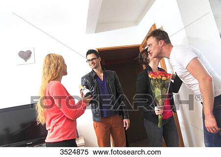 France, couple receiving friends arriving with gifts View Large Photo Image Stock Photography - France, couple receiving friends arriving with gifts. Fotosearch
