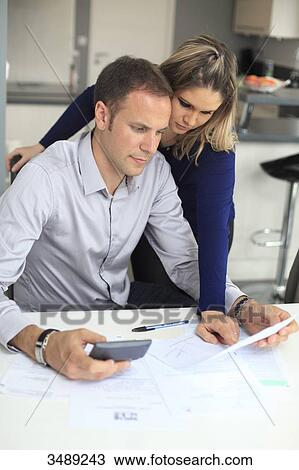 France, couple studying his invoices View Large Photo Image Stock Image - France, couple studying his invoices. Fotosearch