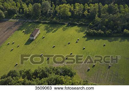 France, Dordogne, aerial view of a green field and haystack between two forests. House on the left View Large Photo Image Stock Image - France, Dordogne, aerial view of a green field and haystack between two forests. House on the left. Fotosearch