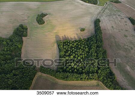France, Dordogne, plowed fields and forest. Pool of light View Large Photo Image Stock Photo - France, Dordogne, plowed fields and forest. Pool of light. Fotosearch