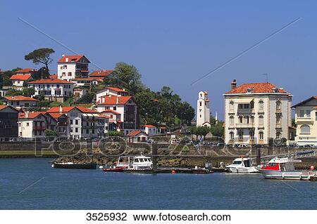 Stock Image - France, French Basque Country, Pyrenees-Atlantiques, Saint Jean de Luz, Ciboure in background. Harbour's entrance.. Fotosearch