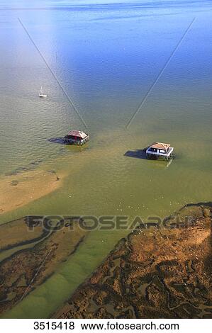 Stock Photo - France, Gironde. Arcachon Bay. Bird Island. Cabin built on stilts.. Fotosearch