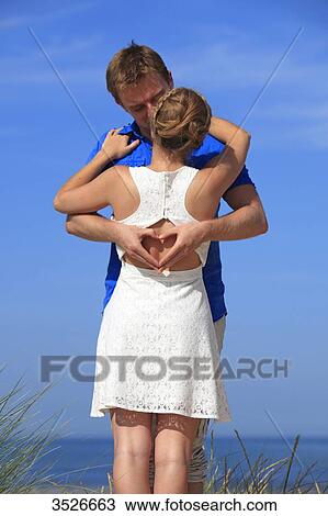 Stock Image - France, happy couple on beach. Fotosearch