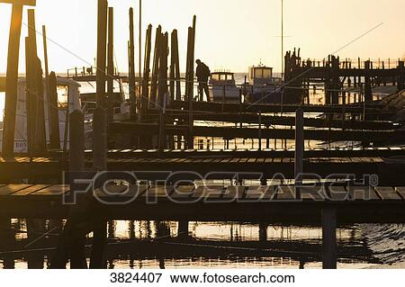 Stock Photo - France, Les Moutiers-en-Retz, harbor of Collet at sunset.. Fotosearch