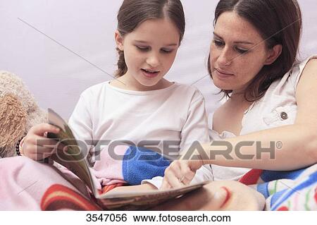 France, little girl reading with her mother at home View Large Photo Image Stock Photograph - France, little girl reading with her mother at home. Fotosearch