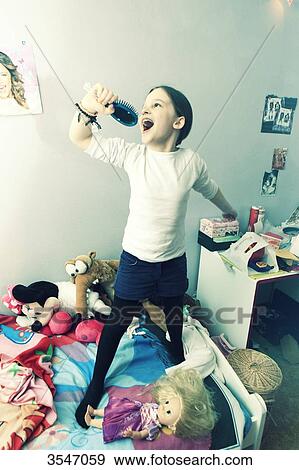 France, little girl singing on her bed at home View Large Photo Image Stock Photo - France, little girl singing on her bed at home. Fotosearch
