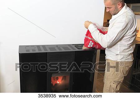 France, man filling a stove View Large Photo Image Stock Photography - France, man filling a stove. Fotosearch