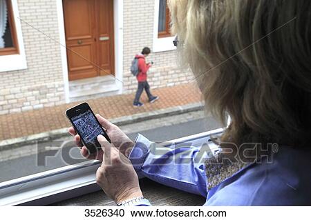 France, mother supervising her son thanks to an application of cellphone localization View Large Photo Image Stock Image - France, mother supervising her son thanks to an application of cellphone localization. Fotosearch
