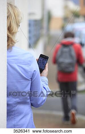 France, mother supervising her son thanks to an application of cellphone localization View Large Photo Image Stock Image - France, mother supervising her son thanks to an application of cellphone localization. Fotosearch
