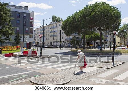 France, Nantes, old woman crossing a lonesome street in the summer. View Large Photo Image Stock Photography - France, Nantes, old woman crossing a lonesome street in the summer.. Fotosearch
