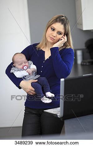 France, new mother working at home View Large Photo Image Stock Photo - France, new mother working at home. Fotosearch