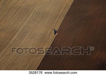 France, Norhern France, Pas-de-Calais. Aerial view of an agricultural vehicle in a field View Large Photo Image Stock Photograph - France, Norhern France, Pas-de-Calais. Aerial view of an agricultural vehicle in a field. Fotosearch
