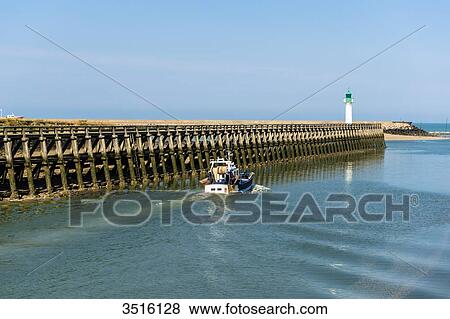 France, Normandy, boat leaving the River Touques for the sea on a beautiful summer day close to the lighthouse View Large Photo Image Stock Photo - France, Normandy, boat leaving the River Touques for the sea on a beautiful summer day close to the lighthouse. Fotosearch