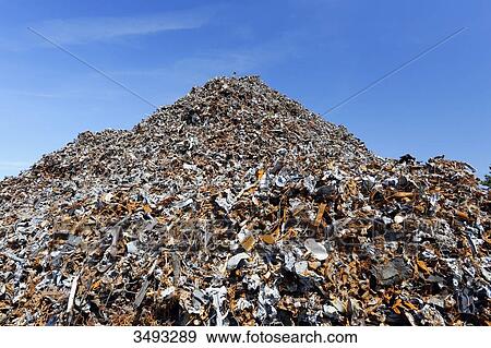 Stock Photo - France, Normandy. Channel. Granville. The port. Mountain of scrap iron from household waste waiting to go to Russia or China for recycling.. Fotosearch