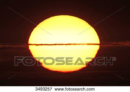 France, Normandy. Closeup of the distorted sun shortly before sunset. View Large Photo Image Stock Photo - France, Normandy. Closeup of the distorted sun shortly before sunset.. Fotosearch
