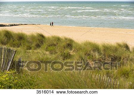 France, Normandy, Couple enjoying a walk along the sea on Cabourg beach View Large Photo Image Picture - France, Normandy, Couple enjoying a walk along the sea on Cabourg beach. Fotosearch