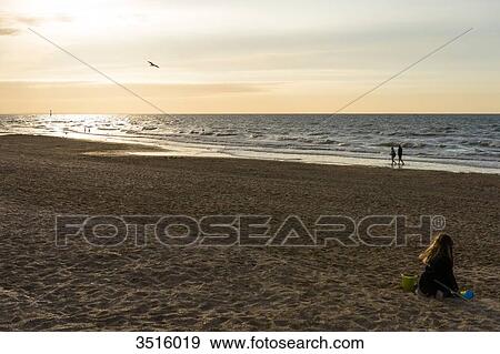 France, Normandy, little girl playing on the beach at sunset View Large Photo Image Stock Photo - France, Normandy, little girl playing on the beach at sunset. Fotosearch