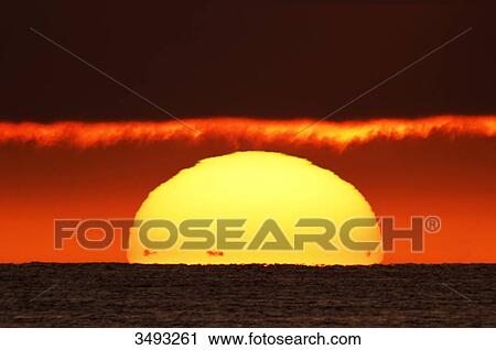 France, Normandy. Montmartin-sur-Mer, Sunset. The black dots at the foot of the sun are the coasts of Jersey View Large Photo Image Stock Image - France, Normandy. Montmartin-sur-Mer, Sunset. The black dots at the foot of the sun are the coasts of Jersey. Fotosearch