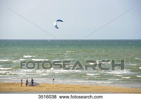 France, Normandy, people enjoying a windy afternoon at the seaside, kite surfing View Large Photo Image Stock Photo - France, Normandy, people enjoying a windy afternoon at the seaside, kite surfing. Fotosearch