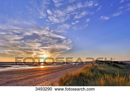 France, Normandy. View of the Regneville-sur-mer Bay and Agon-Coutainville at sunset. High tides period View Large Photo Image Stock Image - France, Normandy. View of the Regneville-sur-mer Bay and Agon-Coutainville at sunset. High tides period. Fotosearch