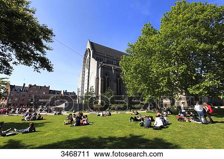 France, North-Eastern France, Lille, people sitting on the lawn in front of Notre-Dame-de-la-Treille Cathedral Basilica, Neo-Gothic style View Large Photo Image Stock Image - France, North-Eastern France, Lille, people sitting on the lawn in front of Notre-Dame-de-la-Treille Cathedral Basilica, Neo-Gothic style. Fotosearch