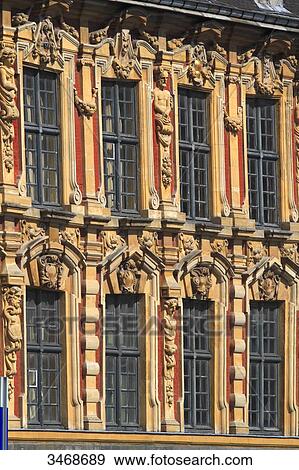 Stock Photo - France, North-Eastern France, Lille, General De Gaulle square, headquarters of the newspaper La Voix du Nord with 3 golden statues at its top (representing 3 French regions). Fotosearch