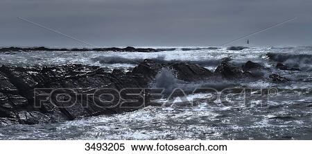 France, panoramic view of a stormy sea crossing a rock slant. Lighthouse right background View Large Photo Image Stock Photography - France, panoramic view of a stormy sea crossing a rock slant. Lighthouse right background. Fotosearch