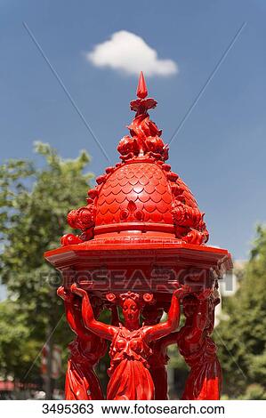 Stock Image - France. Paris 13th district. Avenue d'Ivry. Red Wallace fountain. Fotosearch