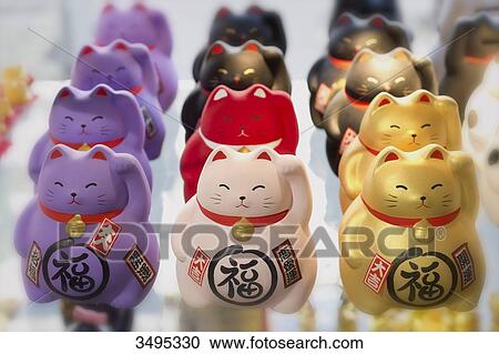 Stock Image - France. Paris 13th district. Parisian Chinatown. Small Japanese cats lucky charm in a store, avenue de Choisy. Fotosearch