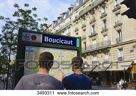Stock Image - France, Paris, 15th arrondissement, Avenue Flix Faure, Boucicaut metro station. 2 men looking at the map of the metro. Fotosearch
