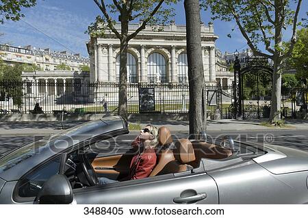 France. Paris 16th district. Corinne, 50, in a convertible in front of the Galliera palace, the Museum of Fashion of the City of Paris. Architect: Leon Ginain (1894). View Large Photo Image Stock Photography - France. Paris 16th district. Corinne, 50, in a convertible in front of the Galliera palace, the Museum of Fashion of the City of Paris. Architect: Leon Ginain (1894).. Fotosearch
