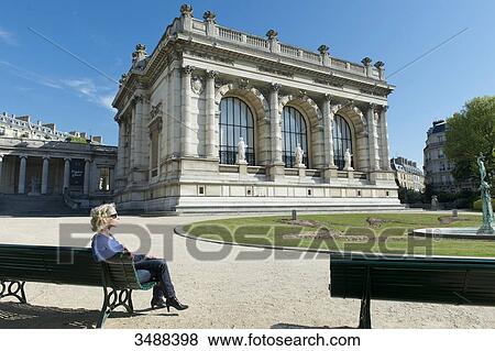 France. Paris 16th district. Woman sitting on a bench in front of the Galliera palace, the Museum of Fashion of the City of Paris. Architect: Leon Ginain (1894). View Large Photo Image Stock Photo - France. Paris 16th district. Woman sitting on a bench in front of the Galliera palace, the Museum of Fashion of the City of Paris. Architect: Leon Ginain (1894).. Fotosearch
