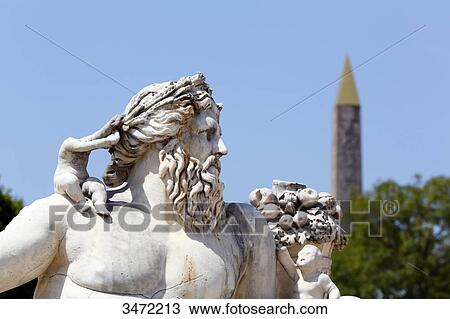 Stock Image - France, Paris. 1st arrondissement. Jardin des Tuileries. Sculpture The Nile by Lorenzo Ottone. The Luxor Obelisk in the background.. Fotosearch