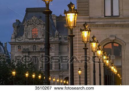 Stock Photo - France, Paris, 1st district, Louvre museum, southern wing by the Jardin du Carrousel at night.. Fotosearch