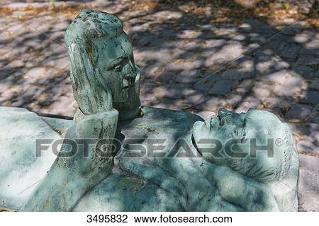 Stock Image - France, Paris 20th district. Pere Lachaise cemetery. Recumbent effigy with its mask. Fotosearch