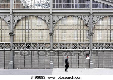 Stock Image - France, Paris, 3rd arrondissement. The Carreau du Temple. Parisian passing the Carreau du Temple.. Fotosearch