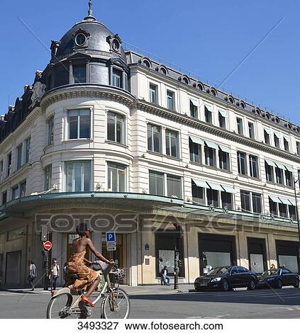 France, Paris, 6th arrondissement, Bon Marche store, young woman riding a bike View Large Photo Image Stock Photo - France, Paris, 6th arrondissement, Bon Marche store, young woman riding a bike. Fotosearch