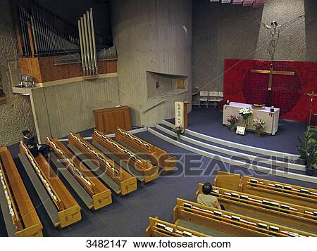 Stock Photo - France, Paris. 8th district. Saint Joseph Church (English Catholic mission). Faithful praying.. Fotosearch