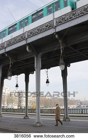 Stock Photograph - France, Paris, Bir-Hakeim Bridge, pedestrian and aerial metro in winter.. Fotosearch
