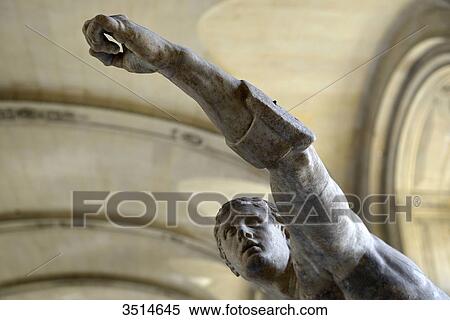 Stock Photography - France, Paris, detail of a marble statue of an ancient soldier arm raised at the Louvre Museum. Fotosearch