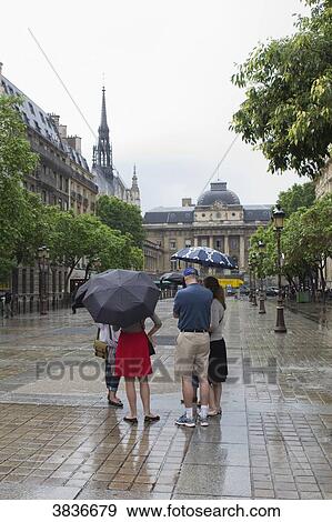 France, Paris, ile de la Cite, tourists in the rain. View Large Photo Image Stock Photo - France, Paris, ile de la Cite, tourists in the rain.. Fotosearch