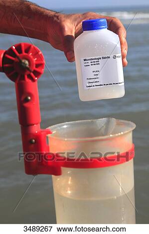 Stock Photo - France, sea water sample, testing bathing water quality. Fotosearch