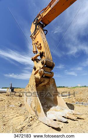 Stock Image - France, Seine-et-Marne. New town of Chessy (Serris-Montevrain-Marne la Vallee). Construction sites (houses, offices). Excavator.. Fotosearch