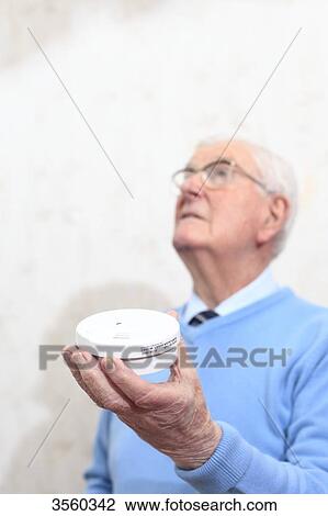 Stock Image - France, senior and smoke detector. Fotosearch