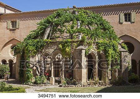 Stock Image - France, Southern France, Vileveyrac, Cistercian abbey of Holy Mary of Valmagne, cloister fountain. Fotosearch