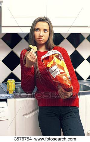 France, teenager at home eating in the kitchen View Large Photo Image Picture - France, teenager at home eating in the kitchen. Fotosearch