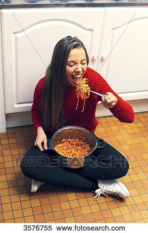 France, teenager at home eating pastas in the kitchen View Large Photo Image Stock Photography - France, teenager at home eating pastas in the kitchen. Fotosearch